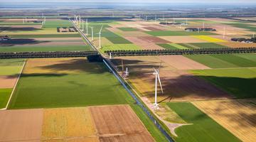 Windmills in a large open green space